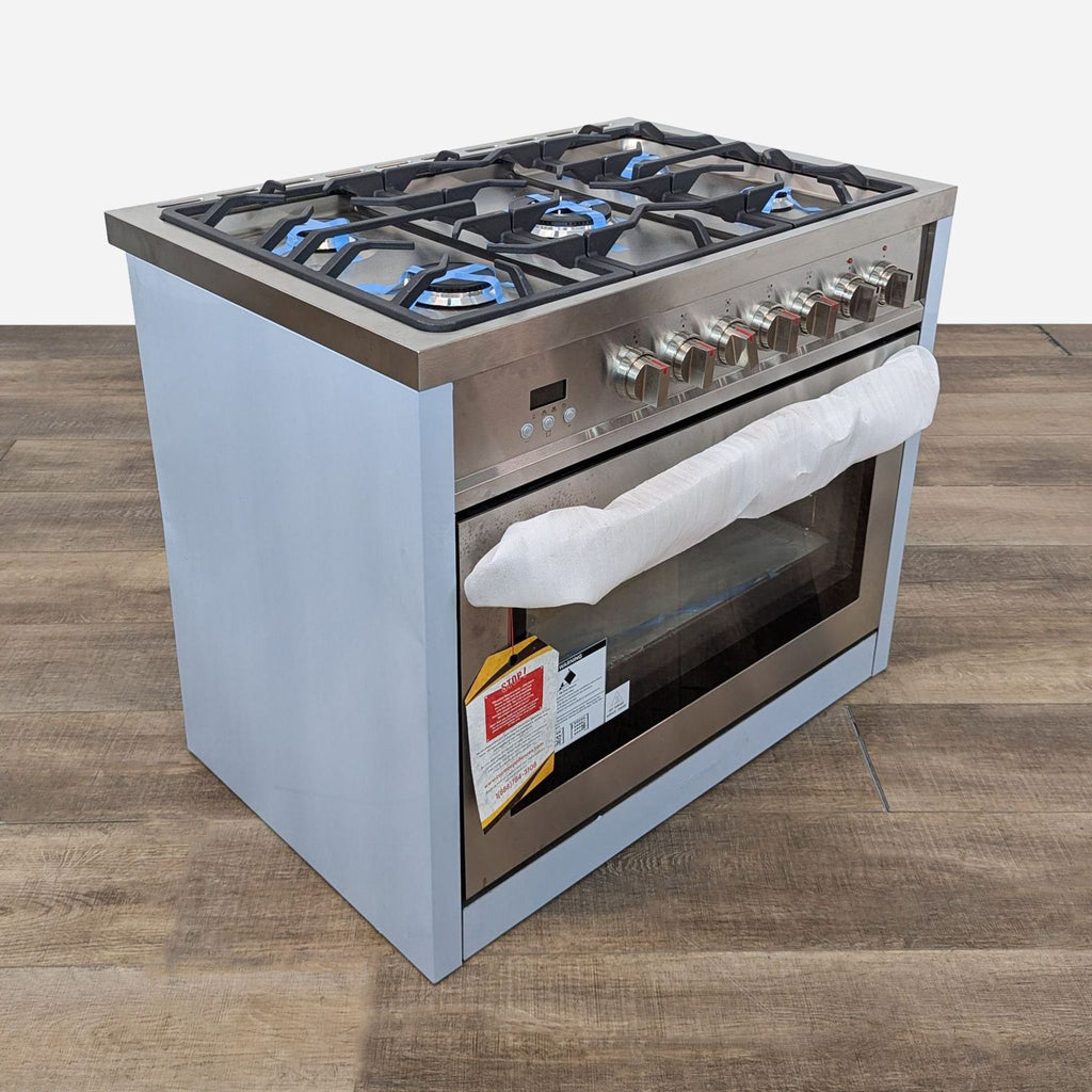 a gas stove with a white towel on top.