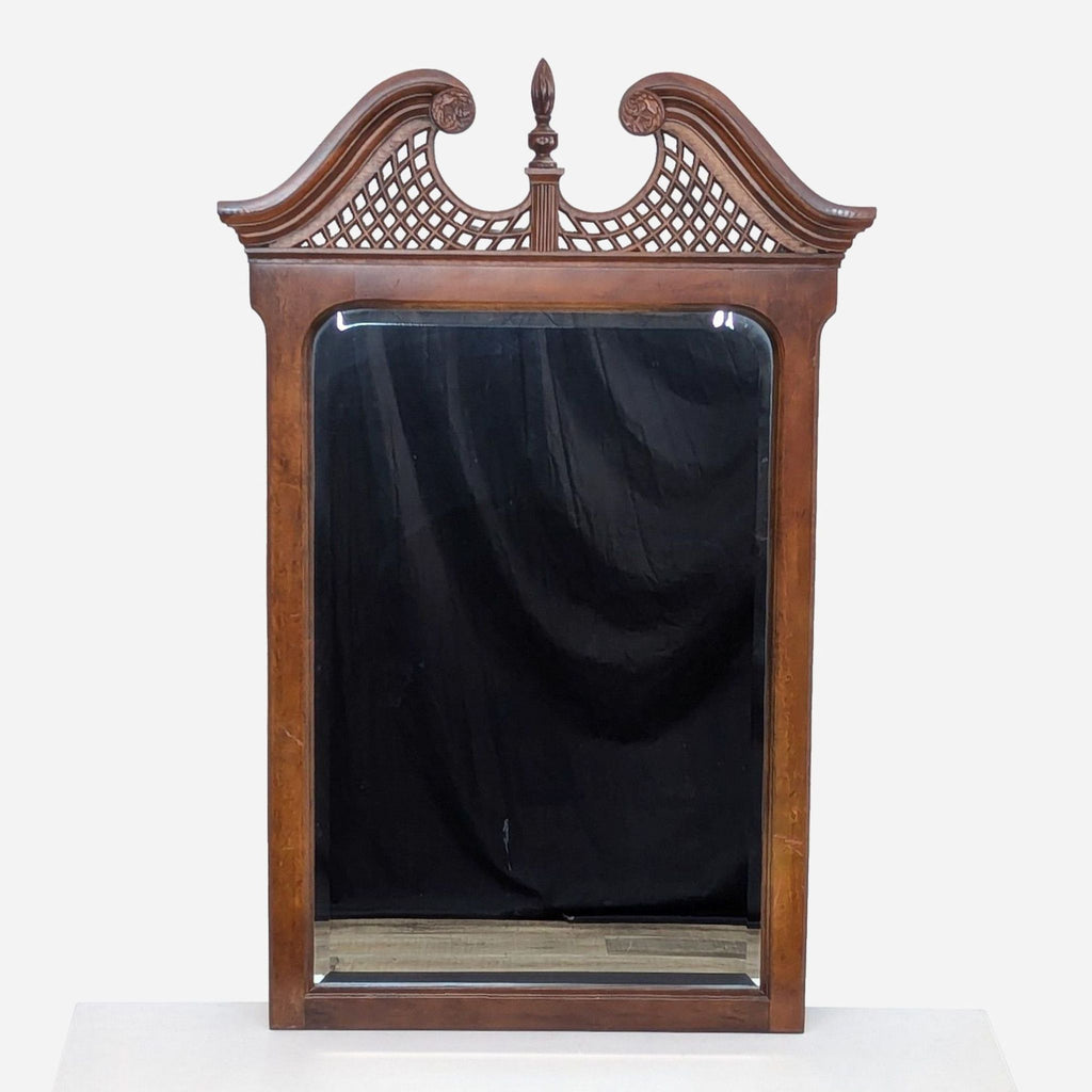 a victorian mahogany mirror with carved woodwork.