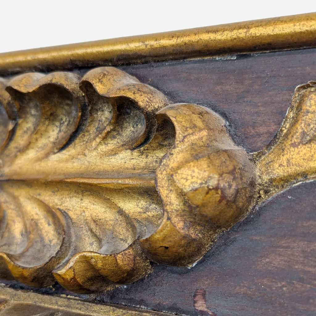 a gilt bronze mirror with a leaf motif