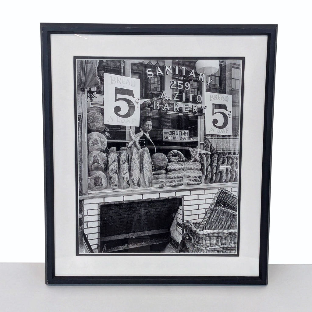 a framed print of a drawing of a shop with a man and woman in front of it.