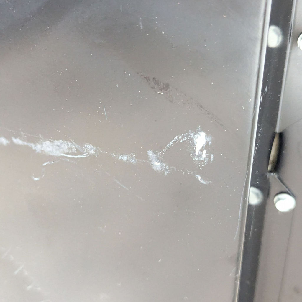 a close up of a metal door frame with a white stain on it.