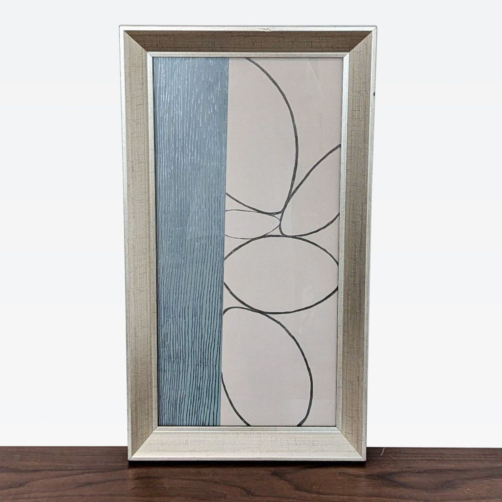 a framed glass painting of a blue and white abstract design.