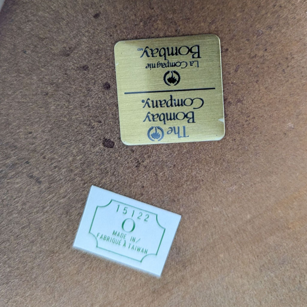 a pair of gold plated metal labels