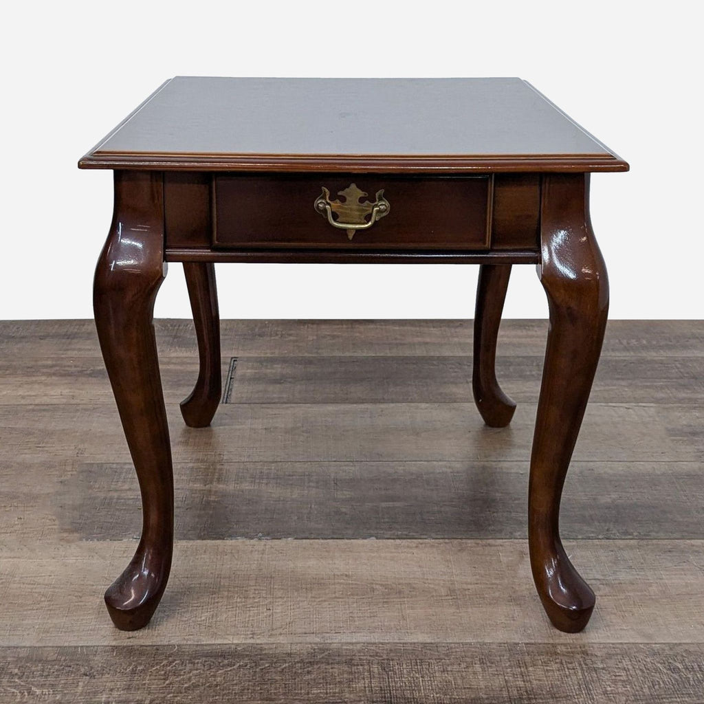 a mahogany side table with a brass plated top.