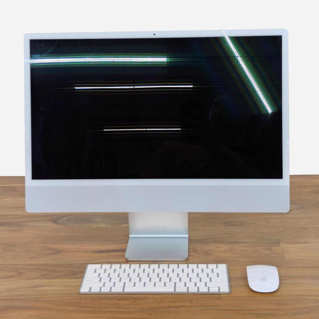 a computer monitor with a keyboard and mouse on a desk.