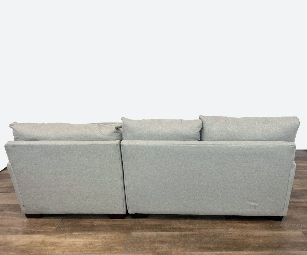 sofa with two cushions and a matching cushion.