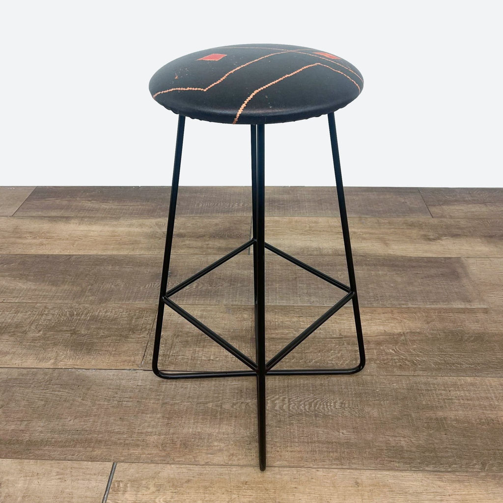 the stool is made of black and red clay.