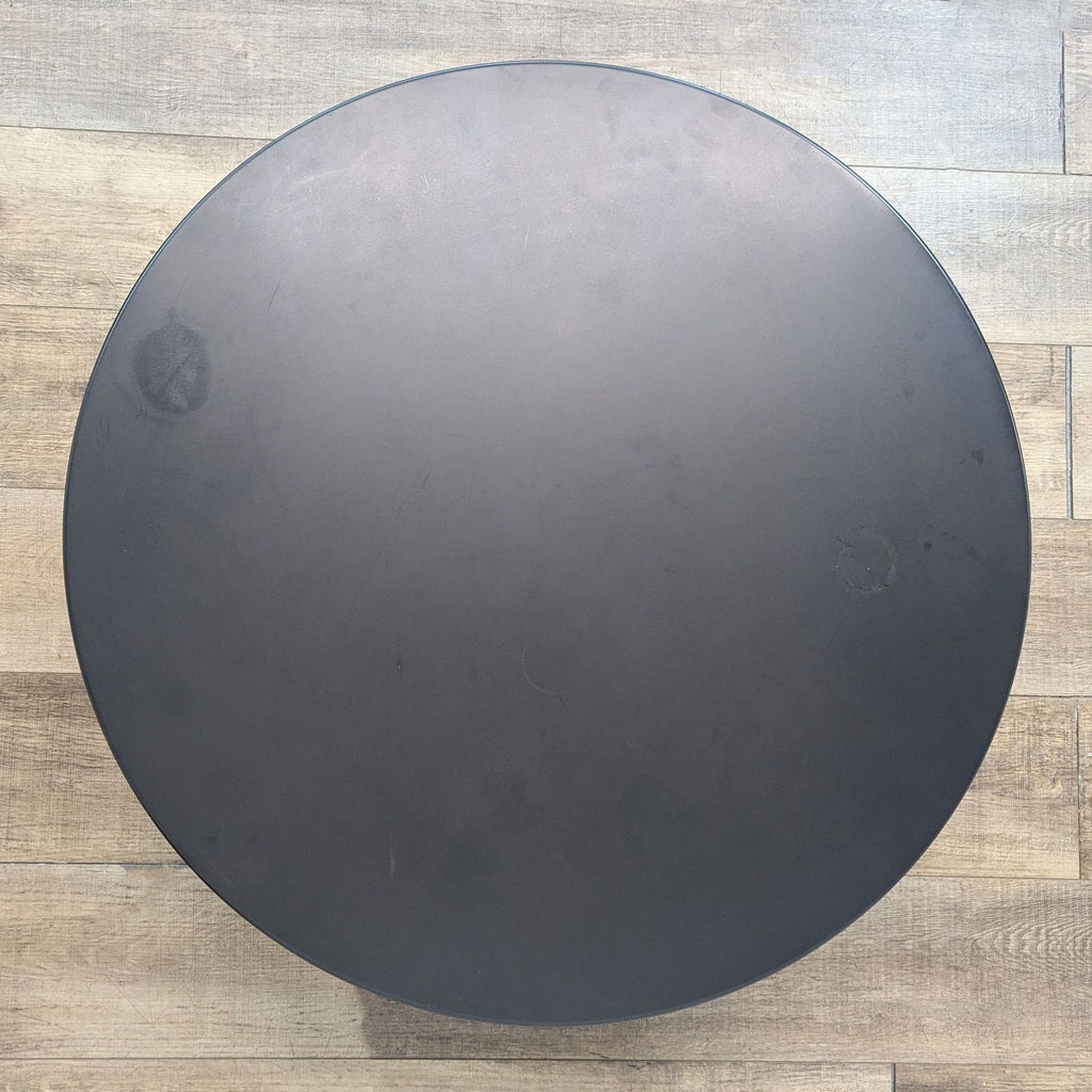 the round table is made from a steel plate.