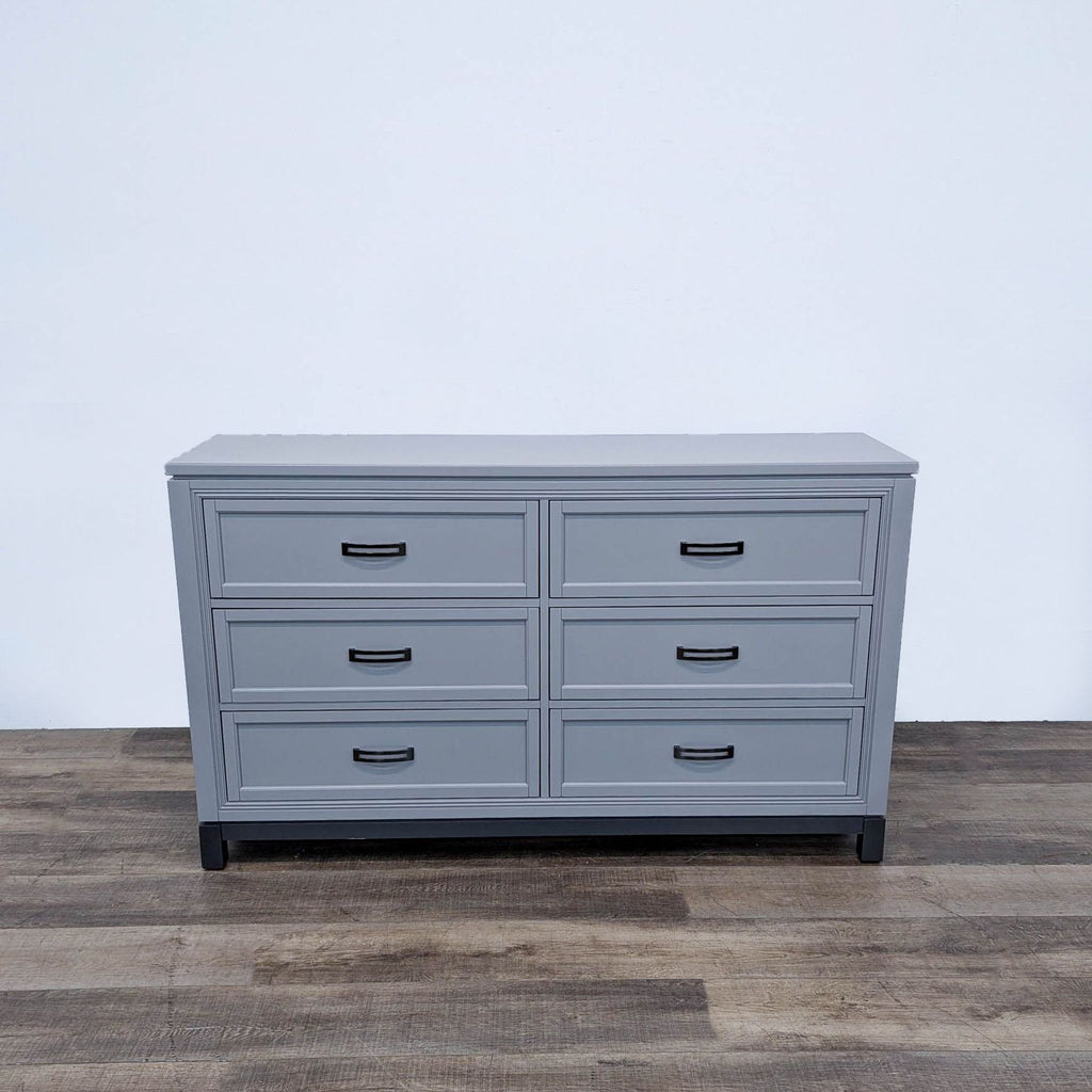 a large grey dresser with four drawers.