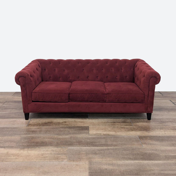 the sofa is a deep red velvet sofa.