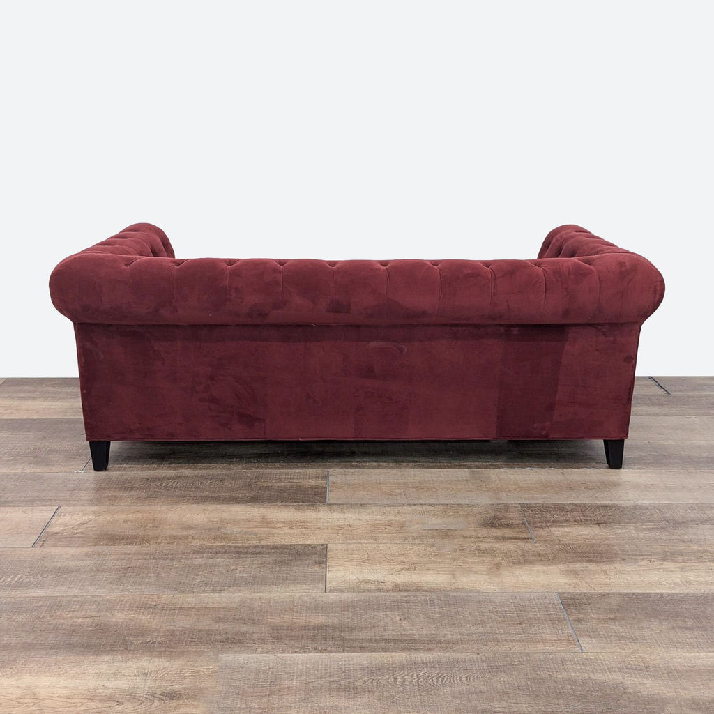 a red velvet sofa in a living room