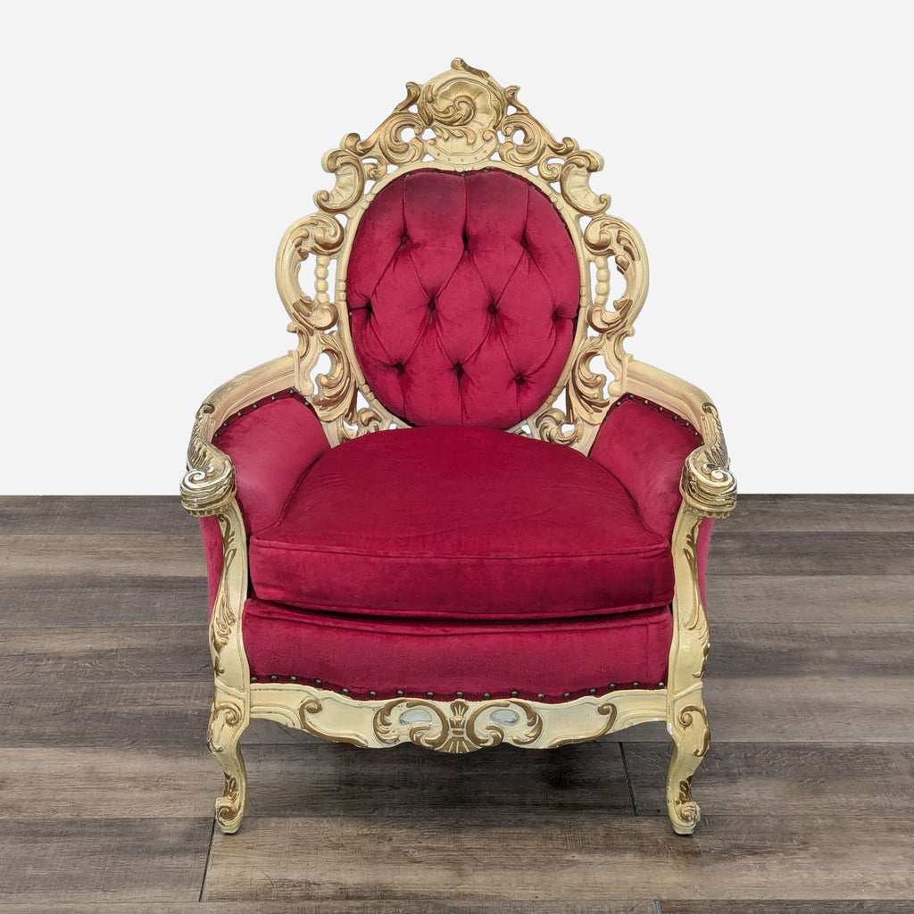 a red velvet chair with gold trim and a gold crown