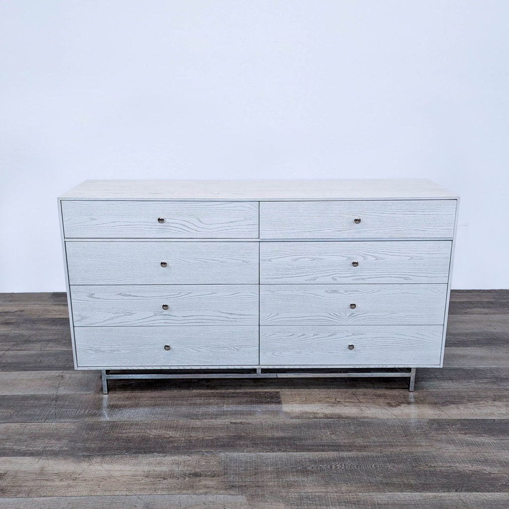 a vintage mid century modern dresser with four drawers.