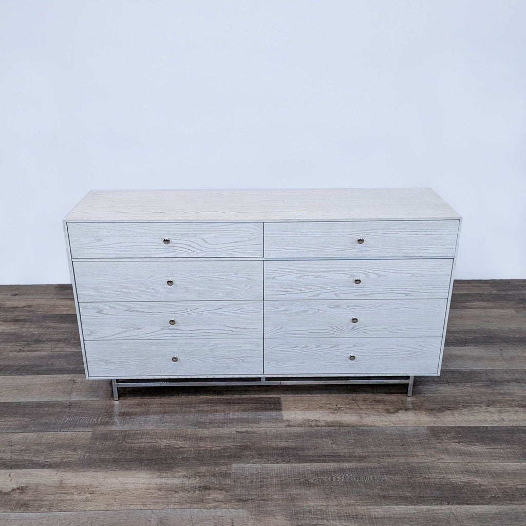 a vintage mid century modern dresser with four drawers.