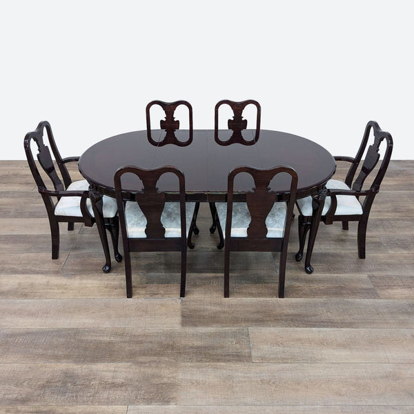 a set of six dining chairs and a table.