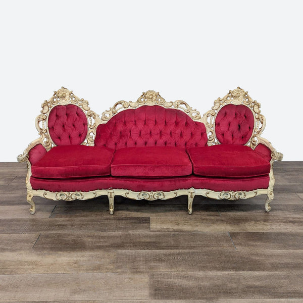 a red sofa with a gold frame and a red sofa