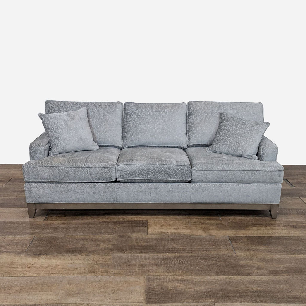 a grey sofa with a grey cushion.