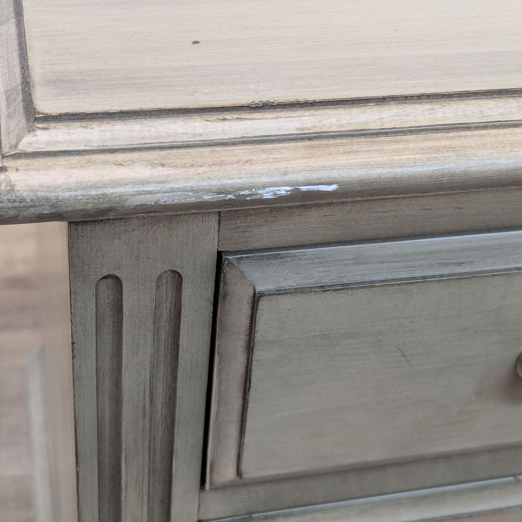 a close up of a grey painted dresser