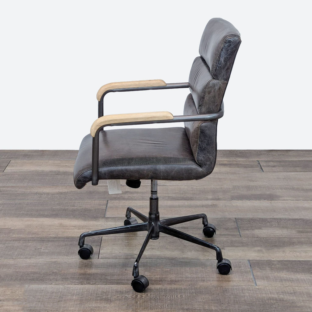 a vintage office chair with a leather seat and a swivel base.