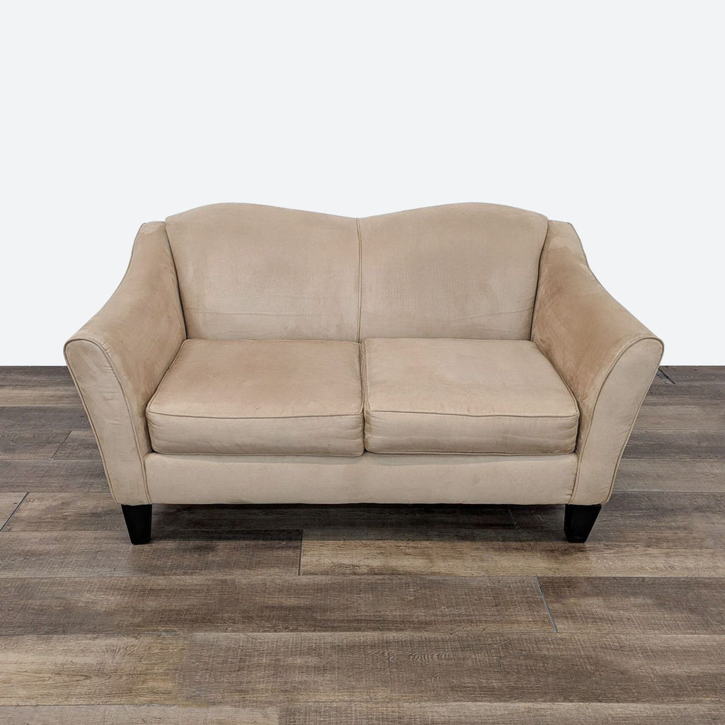 a large, beige leather sofa with a black base.