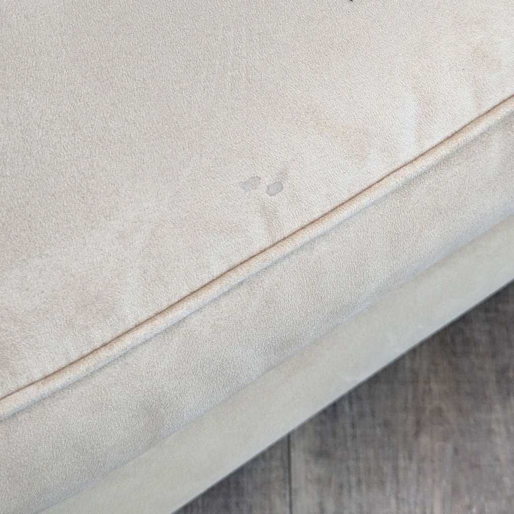 a close up of a white cushion on a wooden floor.