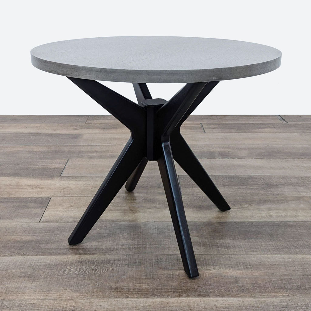 the table is a modern, minimalist design with a concrete top.