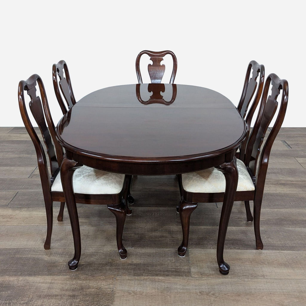 a set of six dining chairs and a table.