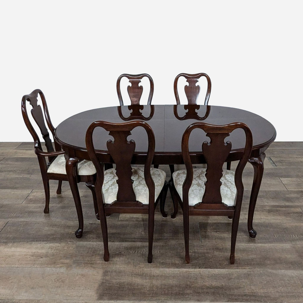 a set of six dining chairs and a table.