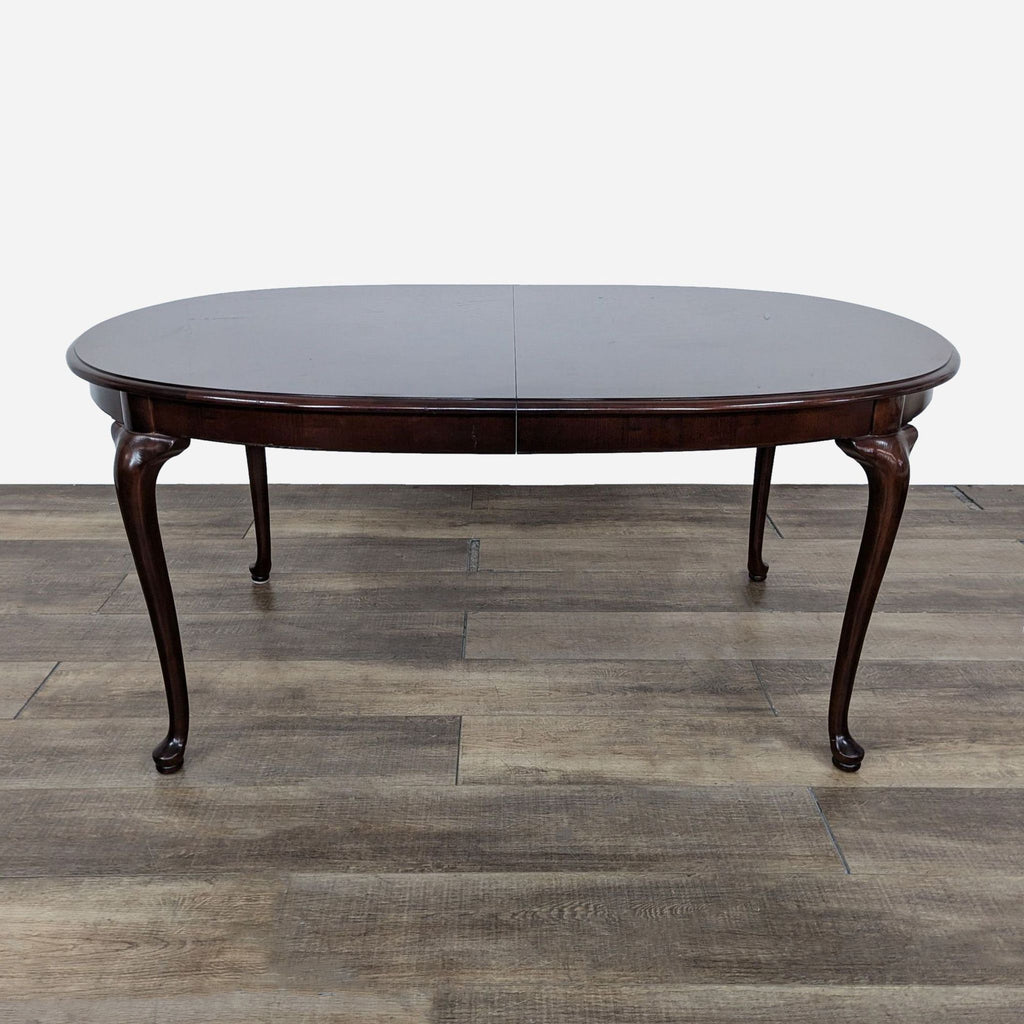 a round coffee table with a dark wood finish.