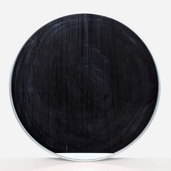 a round metal table with a black painted finish.