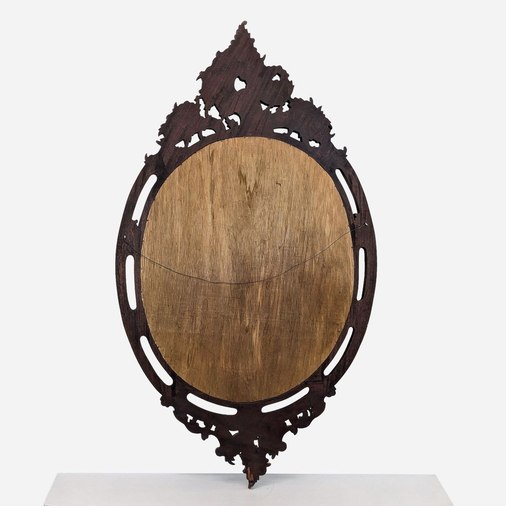 a carved wood oval mirror with a carved frame, 19th century