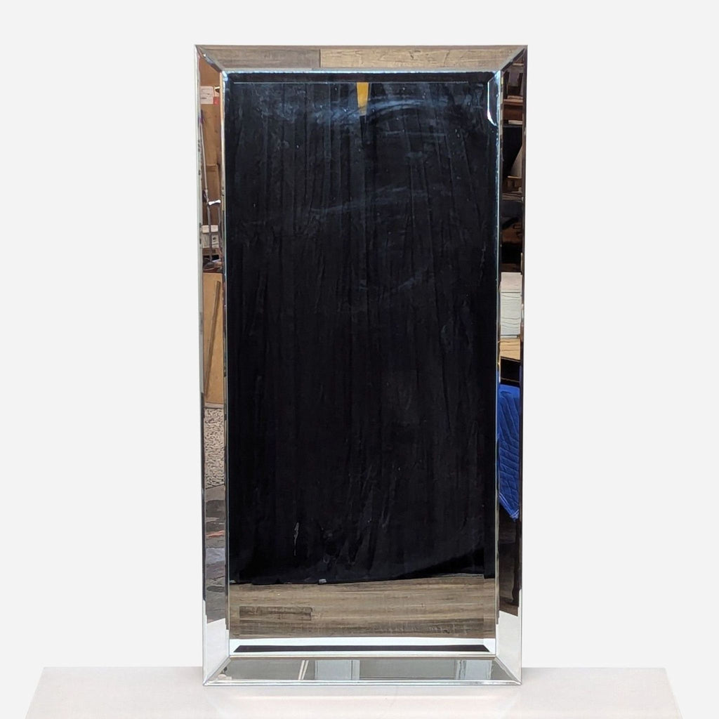 a large, chrome - plated, rectangular mirror with a black frame.