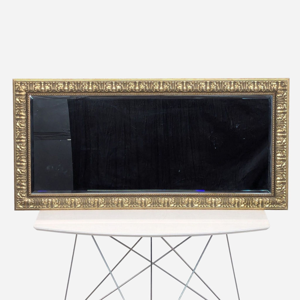 a large vintage mirror with a gold frame