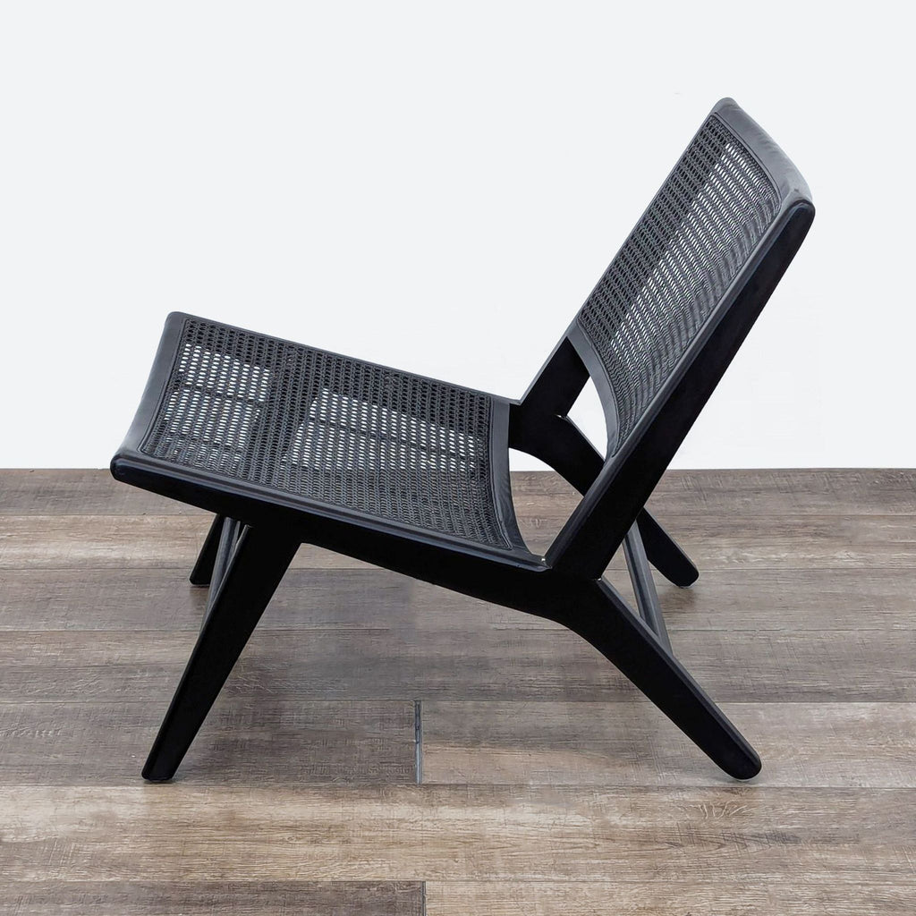 the chair is made of black wood and is made from a single piece of black steel.