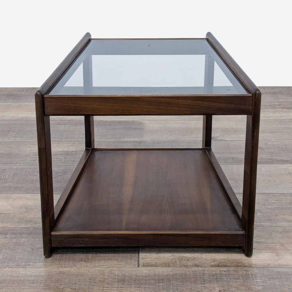 a mid century modern coffee table with a glass top.