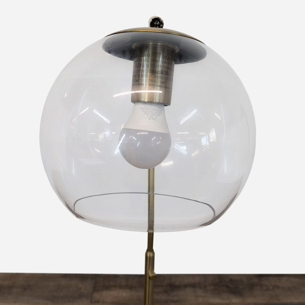 a [ unused0 ] glass and brass table lamp with a glass dome and a glass dome.