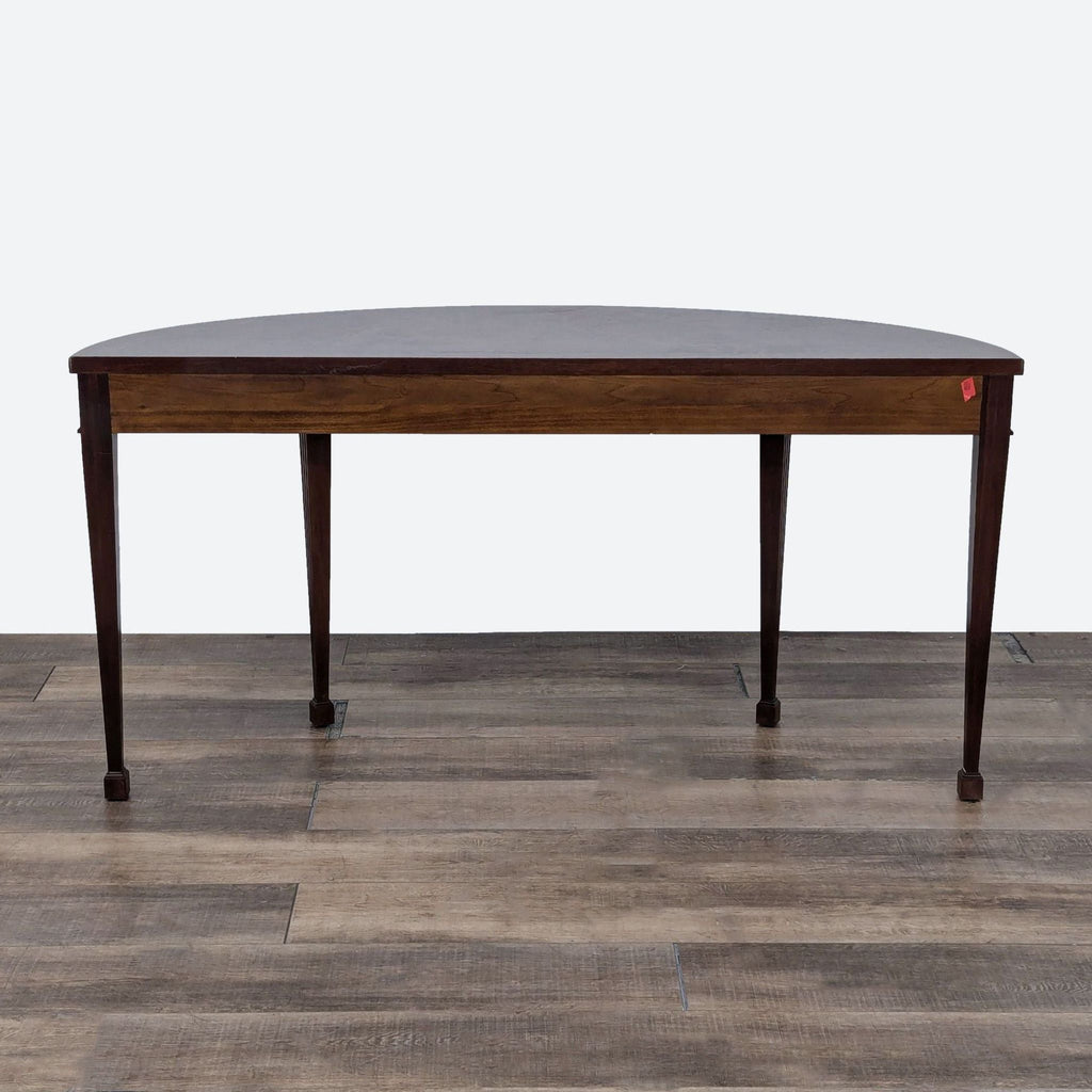 a mahogany dining table with a dark brown finish.