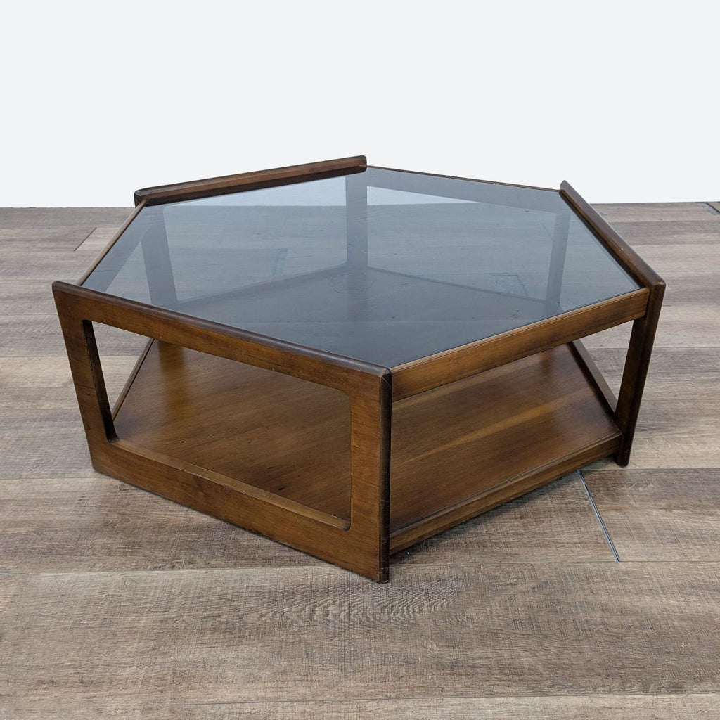 a mid century modern coffee table with a glass top.