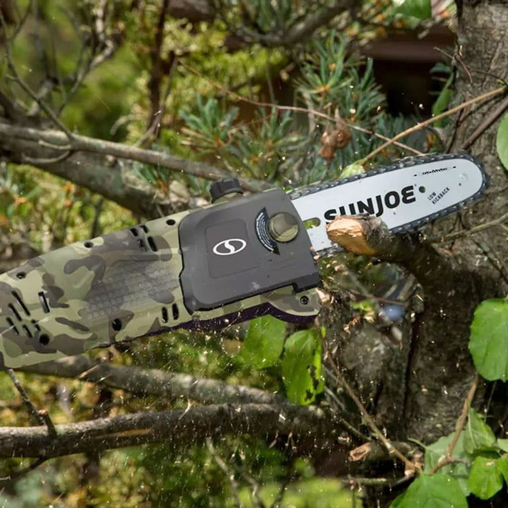 a chainsaw being held in a tree.