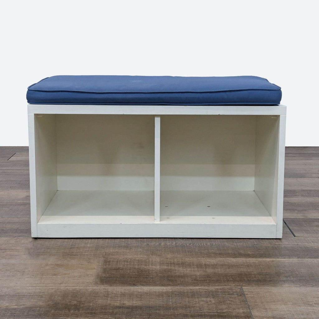 a white and blue storage bench with a blue cushion.