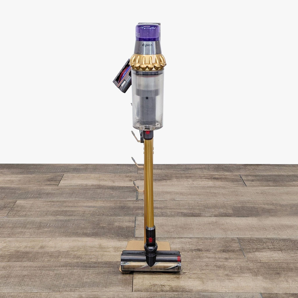 a metal vacuum cleaner with a gold body and a gold body.