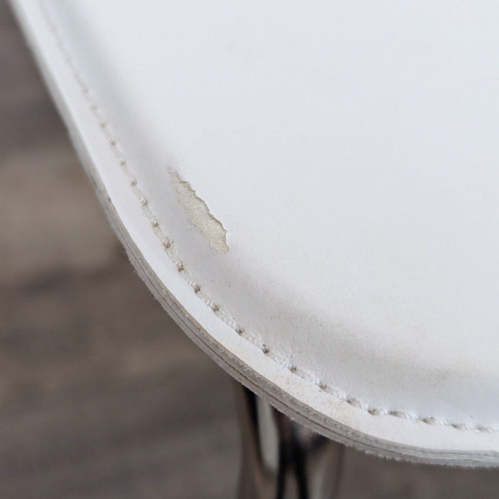 a pair of white leather chairs with a white leather seat and a white leather seat.