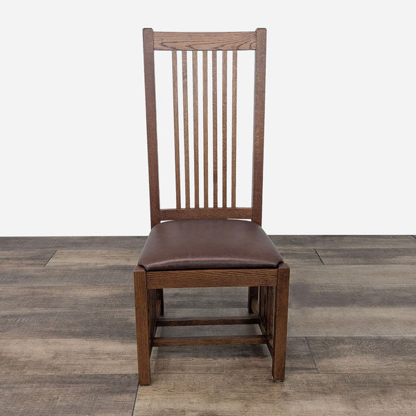 a wooden chair with a brown leather seat.