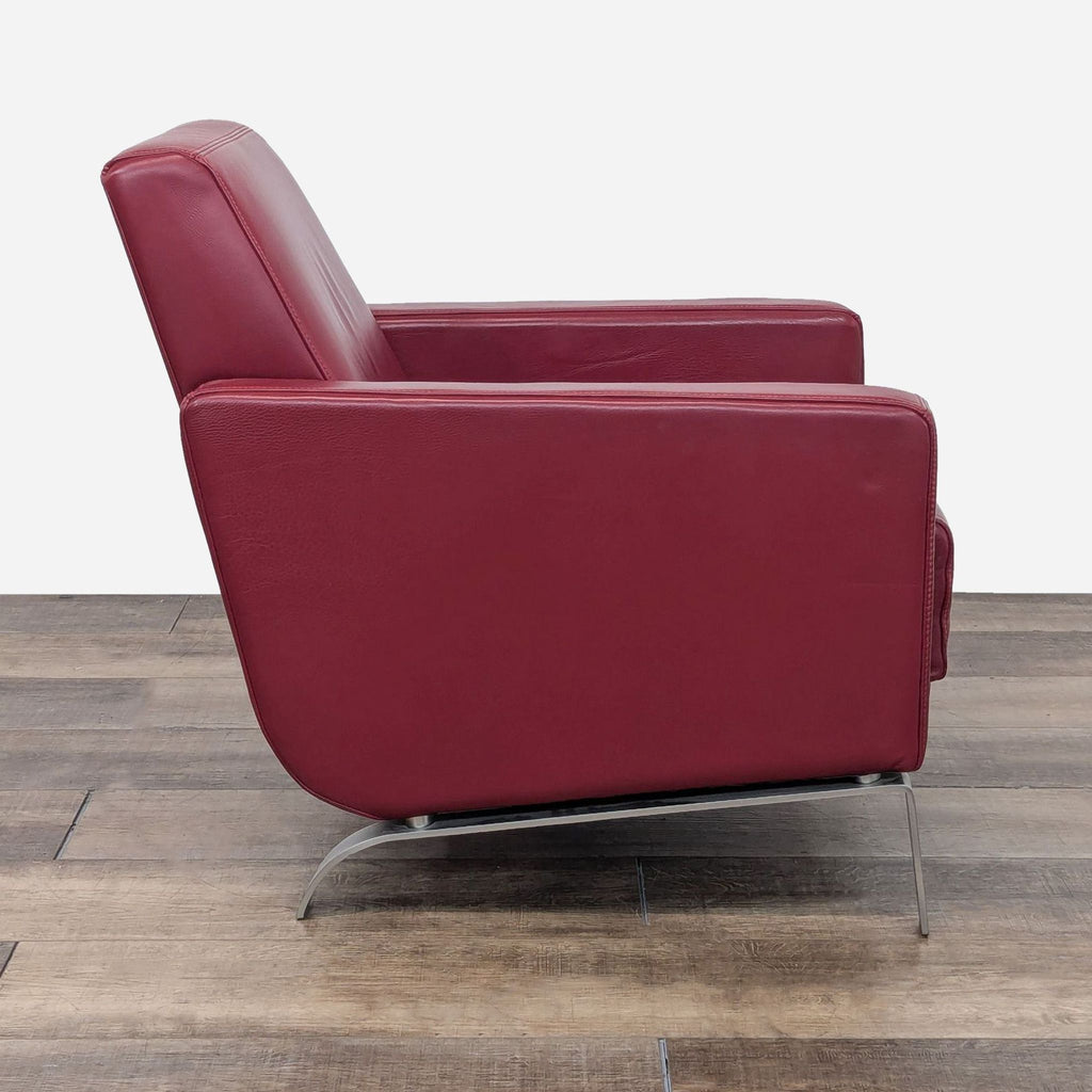 a red leather lounge chair by [ unused0 ], 1960s