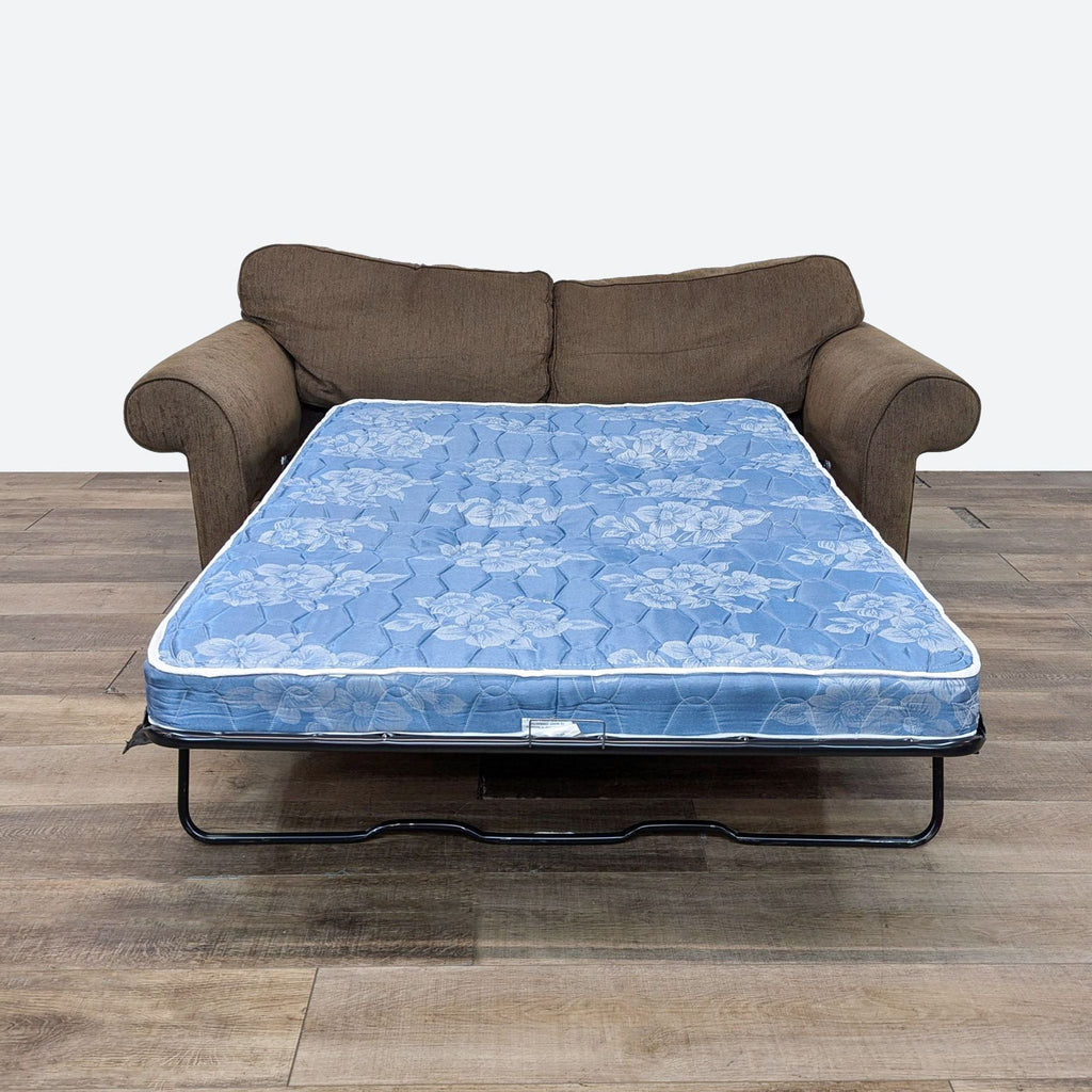 a couch and a mattress on a wooden floor.