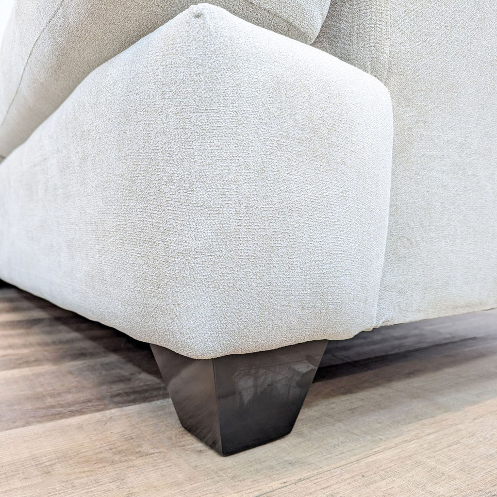 a close up of a couch with a foot support