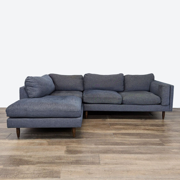 a grey sofa with a dark grey fabric.