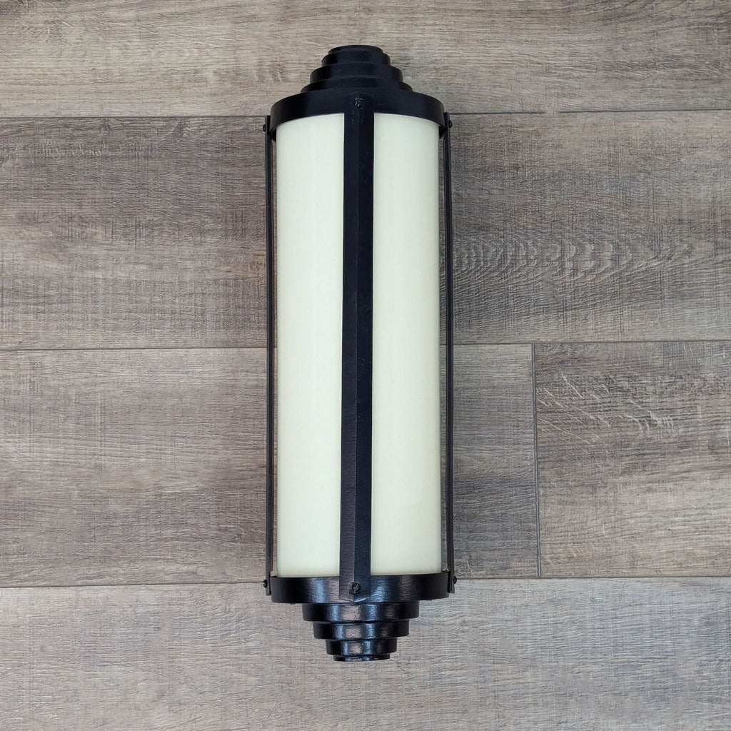 the light fixture is a modern, contemporary style with a black finish.