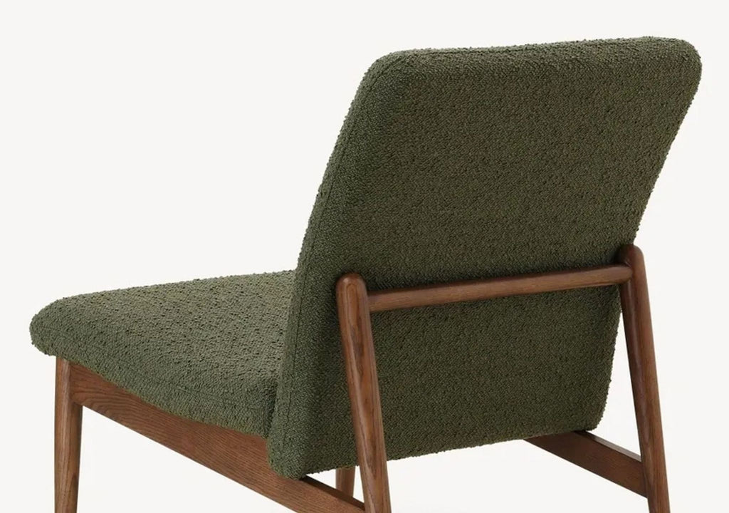 a chair with a green fabric upholstery.