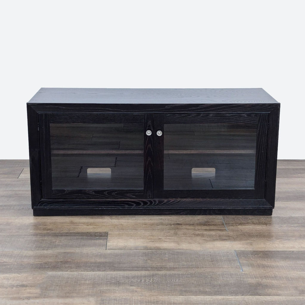 the black tv stand with glass doors